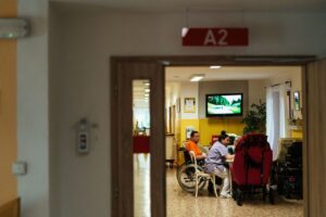 Healthcare professionals caring for elderly patients in a hospital setting, emphasizing support and care.